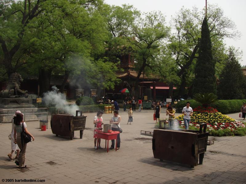 People burning incense at the Lama Temple (Yonghe Lamasery) in Beijing, China