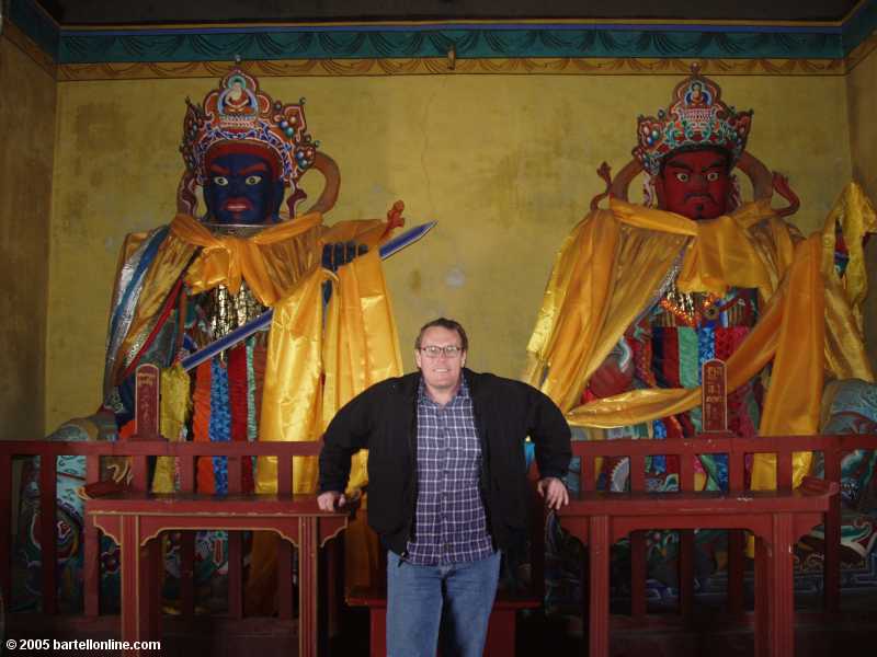 Me with guard figures at Dazhao Temple in Hohhot, Inner Mongolia, China