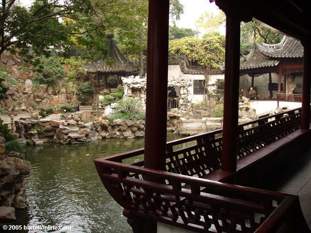 Pond, covered walkway, and building at Yuyuan Garden in Shanghai, China