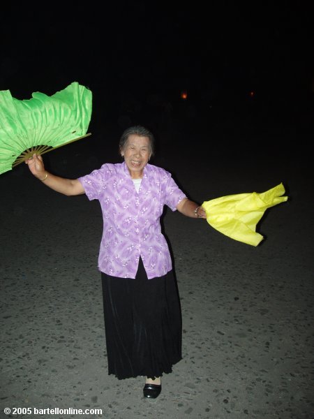 Woman dancing in a square near the train station in Baihe, Jilin, China