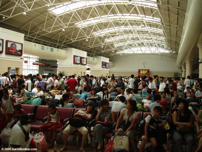 Crowds inside the train station in Dalian, China