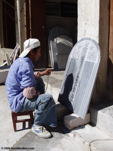 A worker engraves a marble plaque in Dali, Yunnan, China