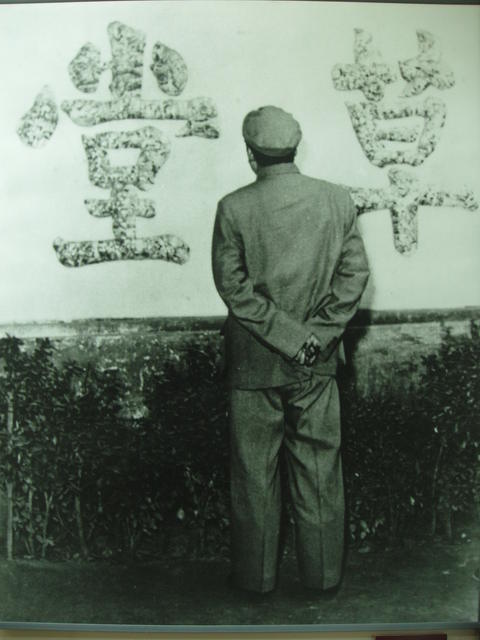 Museum photo of Mao Zedong posing by the Stone Wall at Du Fu's Thatched Cottage in Chengdu, Sichuan, China