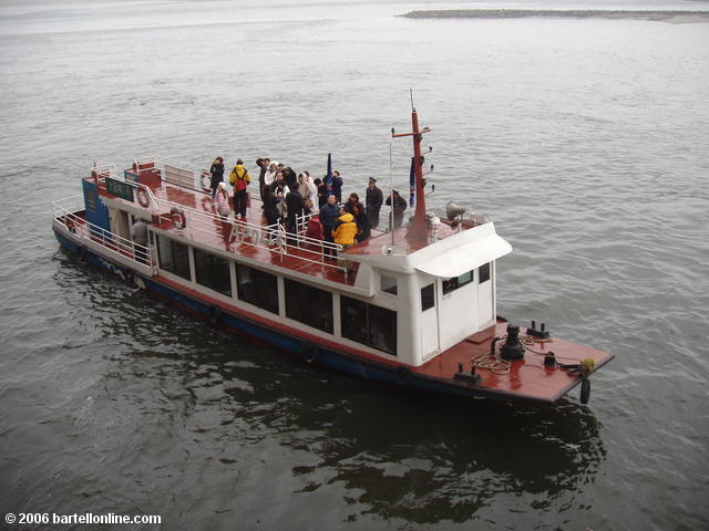 Tourist boat pauses near the Giant Buddha in Leshan, Sichuan, China