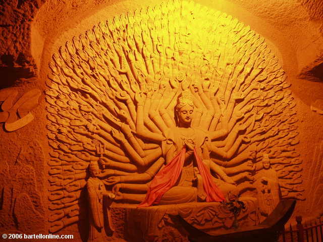 Bodhisattva with many arms along a path to the Giant Buddha in Leshan, Sichuan, China