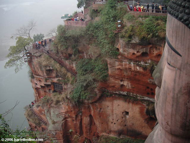 Narrow stairs wind down the cliff beside the Giant Buddha in Leshan, Sichuan, China