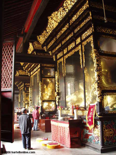 Encased statues in the Hall of Three Purities at Qingyang Temple in Chengdu, Sichuan, China