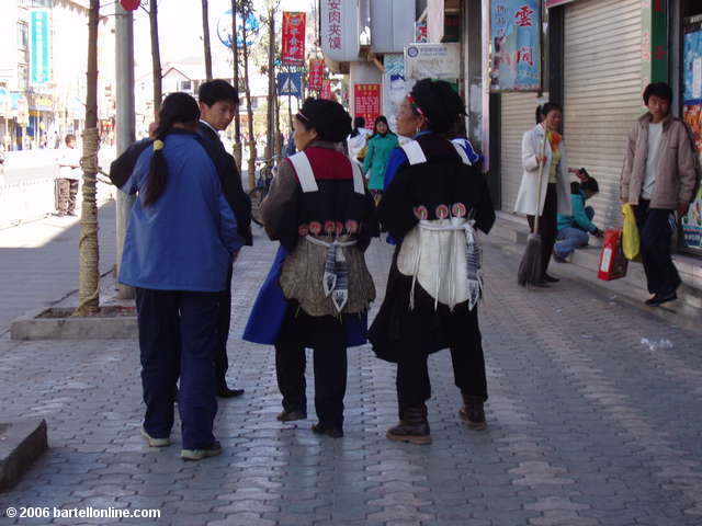 Women in ethnic dress on the streets of Lijiang, Yunnan, China