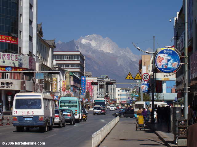 Jade Dragon Snow Mountain looms above the new town streets of Lijiang, Yunnan, China