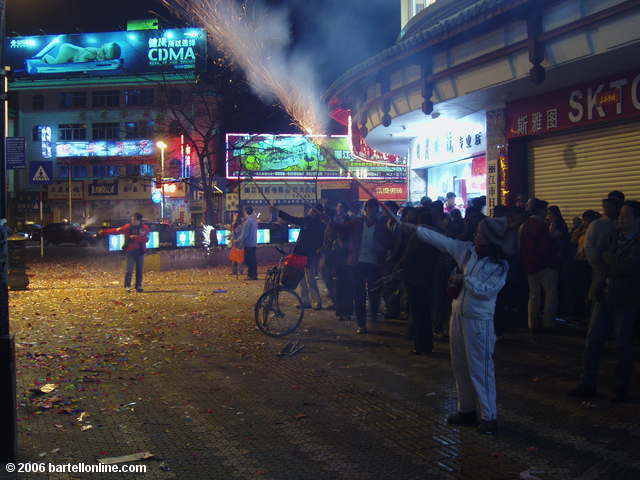 People celebrate the Lunar New Year with fireworks on a street in Lijiang, Yunnan, China