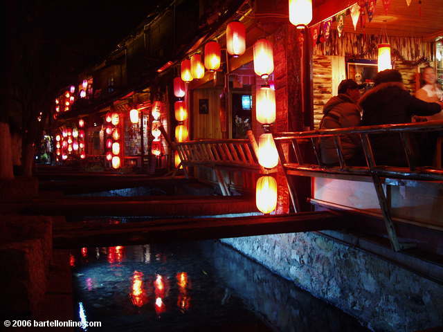 Night view of a restaurant beside a canal in the Old Town of Lijiang, Yunnan, China