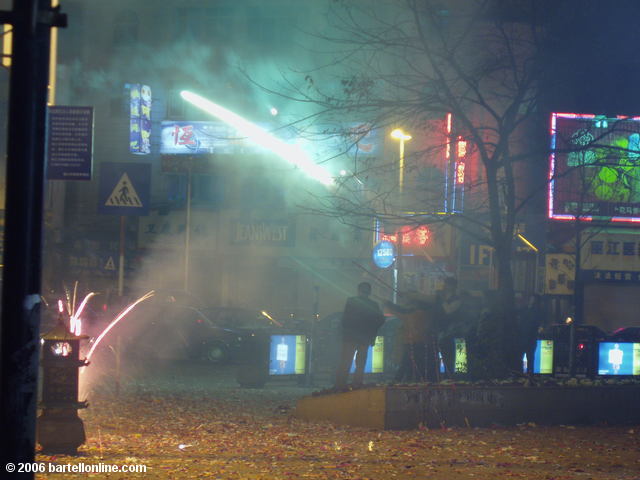 Smoke from Lunar New Year fireworks fills the air on a street in Lijiang, Yunnan, China