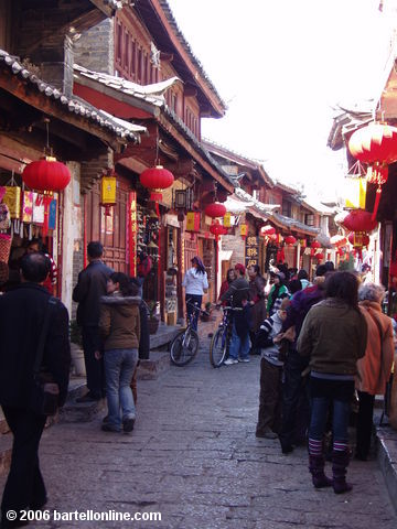 Holiday tourists on a narrow street in the Old Town of Lijiang, Yunnan, China