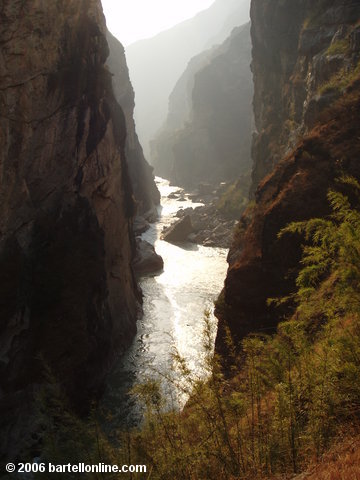 View of cliffs and the Jinsha River (which later becomes the Yangtze) in a narrow section of Tiger Leaping Gorge in Yunnan, China