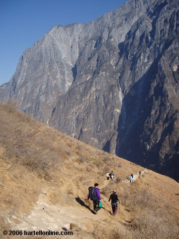 Backpackers descend down towards the road from the upper trail through Tiger Leaping Gorge in Yunnan, China