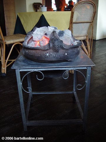 Charcoal tableside heater in a restaurant in Zhongdian ("Shangri-La"), Yunnan, China