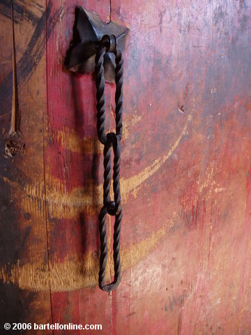 Wrought iron chain on a wooden door in the Songzanlin Monastery near Zhongdian ("Shangri-La"), Yunnan, China